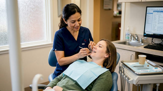 Dentist examining a patient's teeth for biofilm