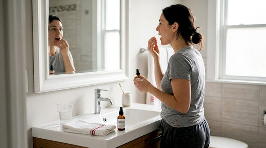 Woman using therapeutic oral spray in bathroom