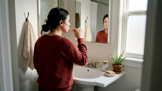 Woman brushing teeth with bamboo toothbrush