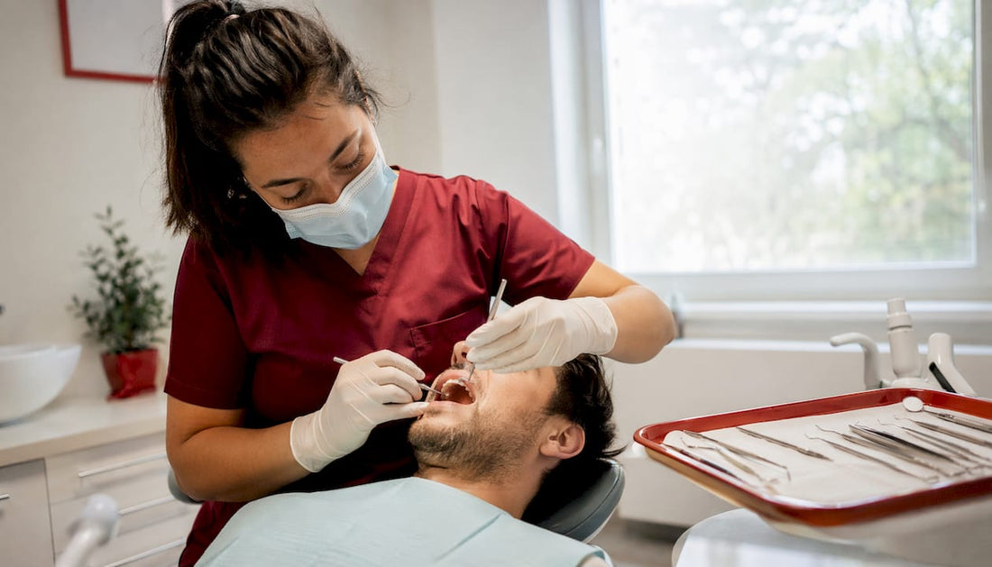 Dentist examining patient gums and teeth