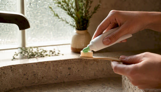 Applying natural toothpaste on toothbrush