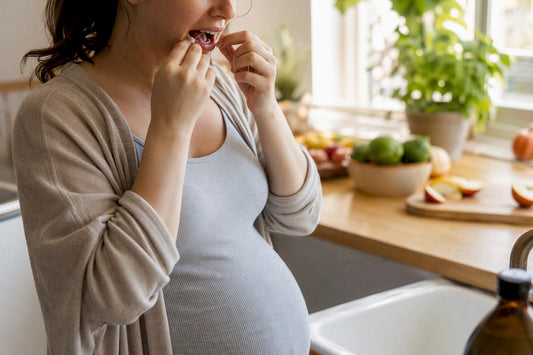 Pregnant woman gently flossing gums