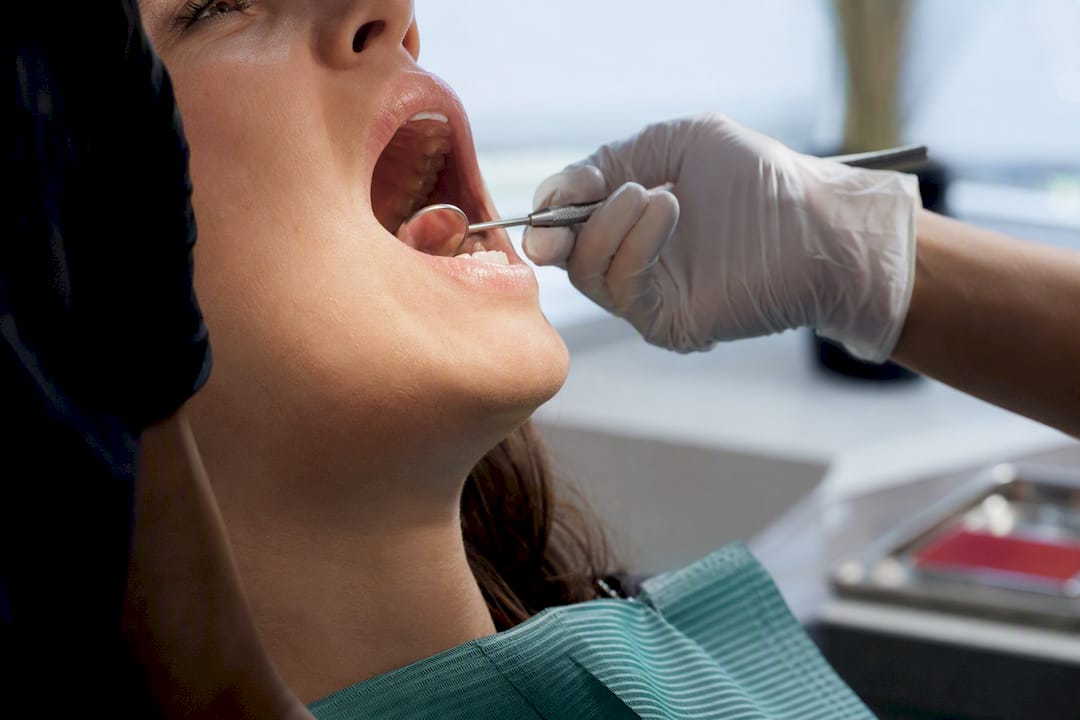 Clinician examining a patient’s sensitive gums