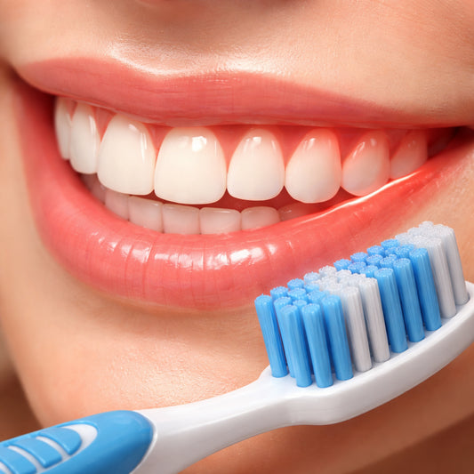 A realistic close‑up of a smiling mouth with highlighted gum line, showing gentle swelling and a toothbrush nearby. Alt: gum sensitivity assessment illustration