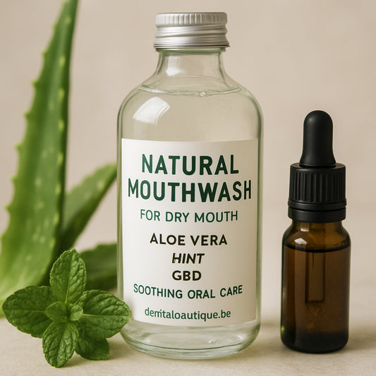 A close‑up of a clear glass bottle of natural mouthwash surrounded by aloe leaves, mint sprigs, and a small CBD oil dropper. Alt: natural mouthwash for dry mouth, aloe vera, mint, CBD soothing oral care